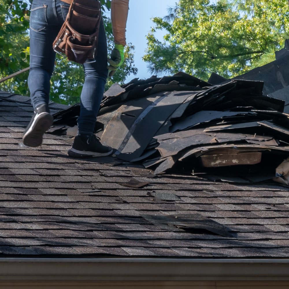 Skilled technician from 1907 Roofing inspecting roof damage to provide expert repair services in Oklahoma City
