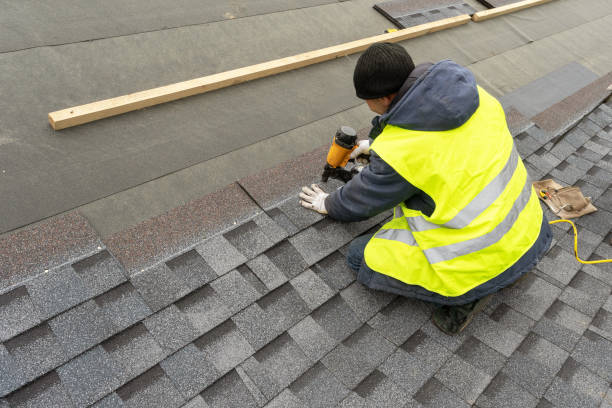 Roofer repairing damaged roof section above a suburban Union City home