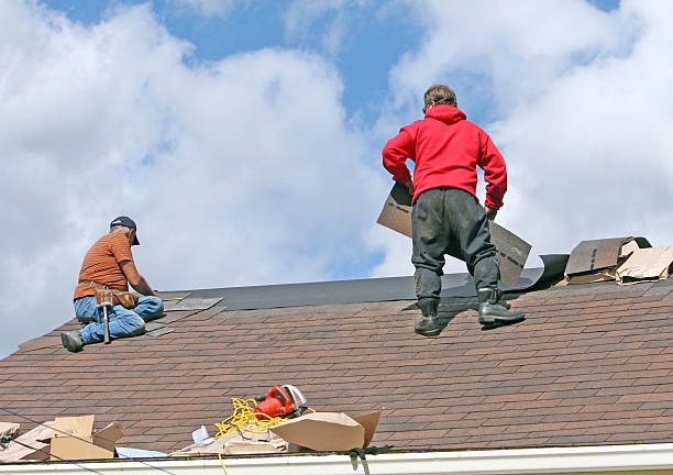 Crew securing damaged shingles after sudden roof leak on Shawnee home