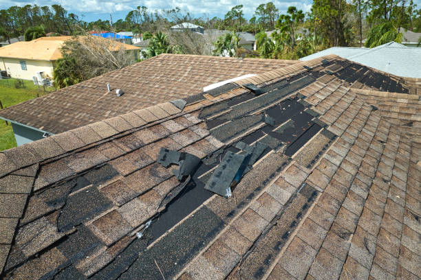 Roofing team replacing storm-worn shingles on an occupied Norman home during a planned project