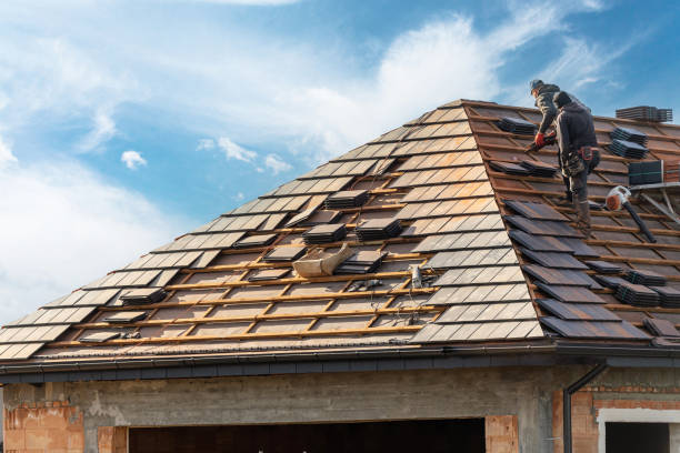 Roofers replacing damaged shingles on a suburban Piedmont home after storm wear